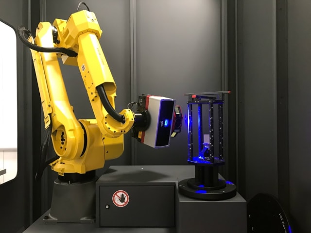 The blue light special. Robotic arm is programmed to travel along a path to automate 3D scanning of parts for reverse engineering.